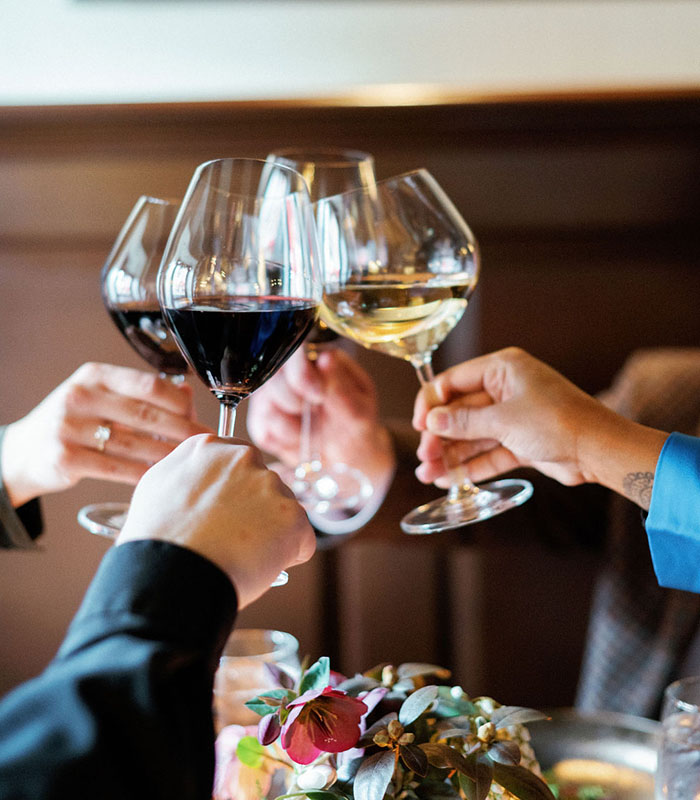 Group of friends clinking wine glasses in a celebratory toast